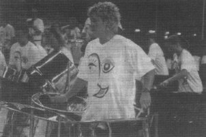 A clear shot of PANchs T-shirt on the lady playing the shiny 3 Cello pans