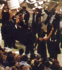 Dr Jennine Remy, on the left arm of a band member, escorted through the avenue of honour